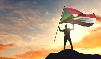 Man holding a Sudan flag
