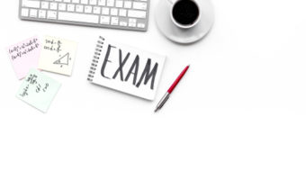 Exam cards with laptop on white background